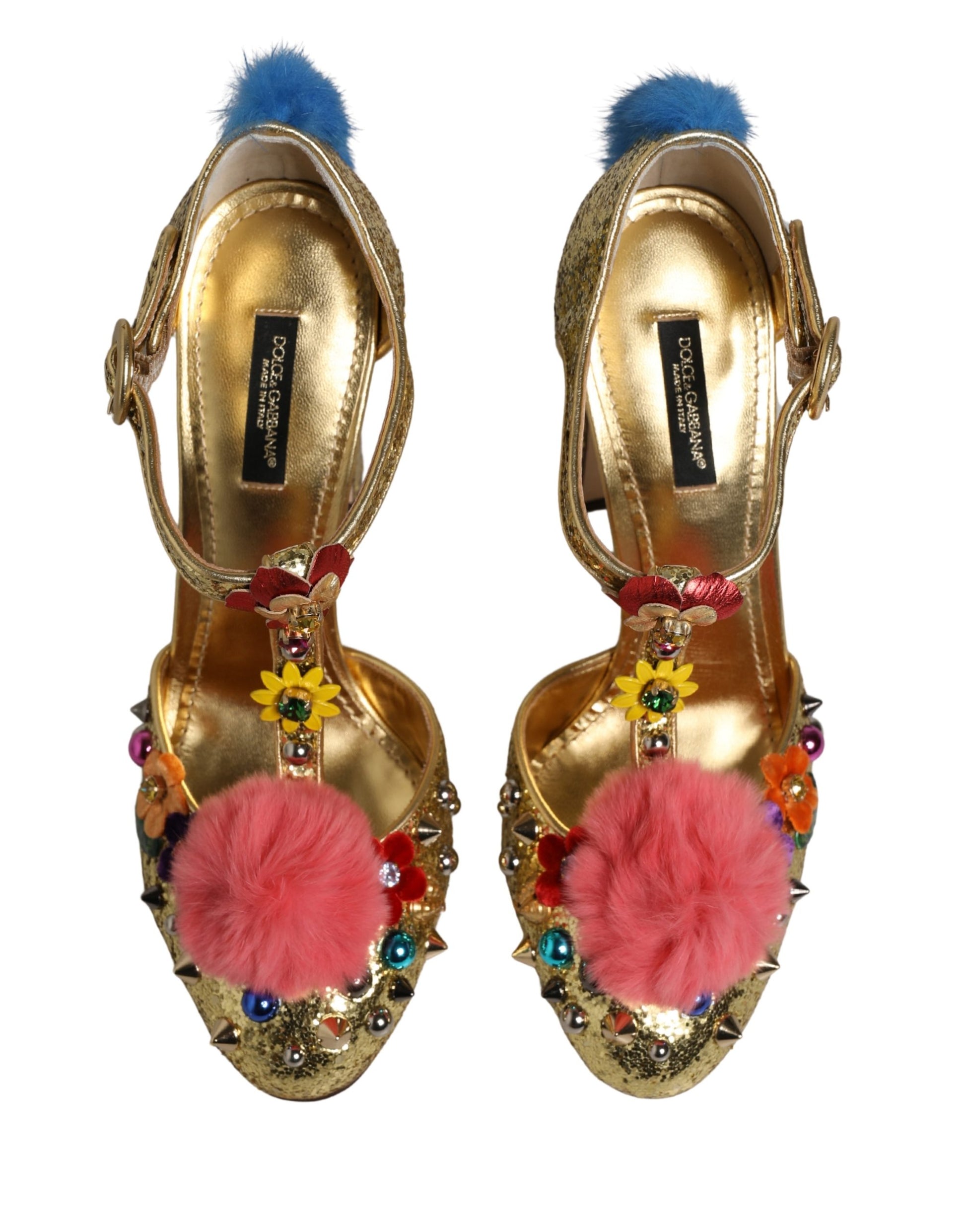 Dolce & Gabbana gold glitter T-strap heels with pink fur pom-poms, floral embellishments, studs, and blue heel trim.