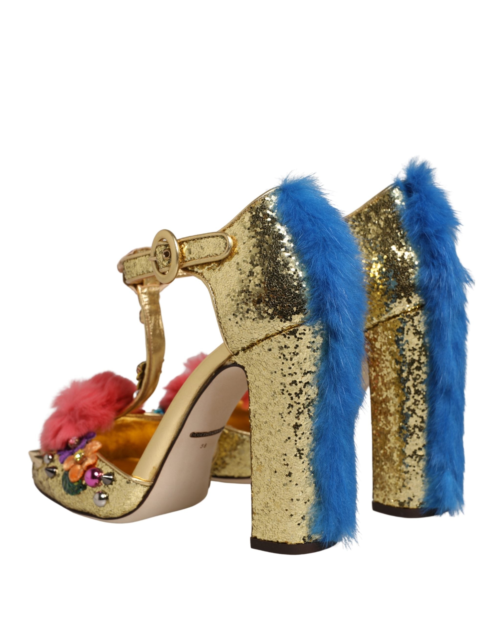 Gold glitter block-heel T-strap sandals with blue fur trim on the heel and decorative floral embellishments.