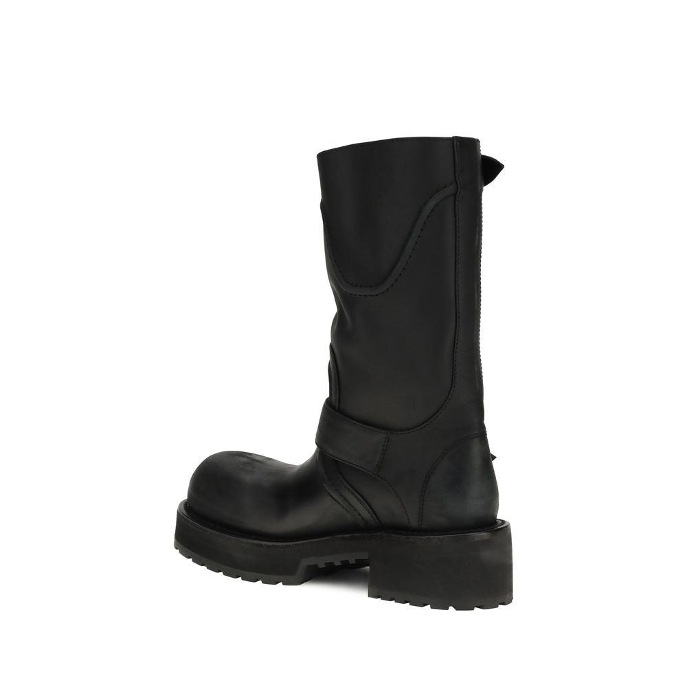 Balenciaga black calf leather, mid-calf lug-sole biker boots with a rounded toe and structured shaft.