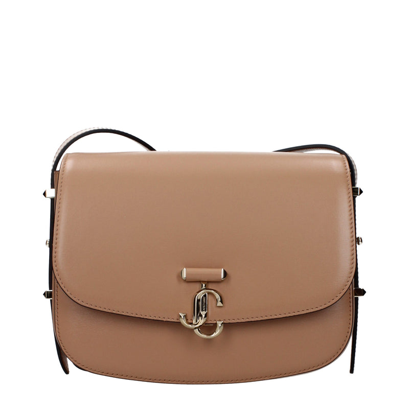 Brown leather crossbody bag with a curved flap and gold JC clasp closure