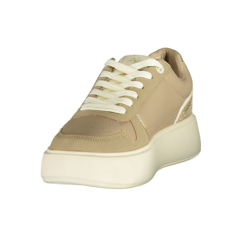 Beige polyurethane women’s platform sneaker with white laces and gold-tone metallic detailing on the heel.