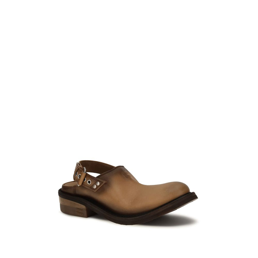 Miu Miu brown calf leather mules with a slingback buckled strap, round toe, and thick, chunky rubber sole.