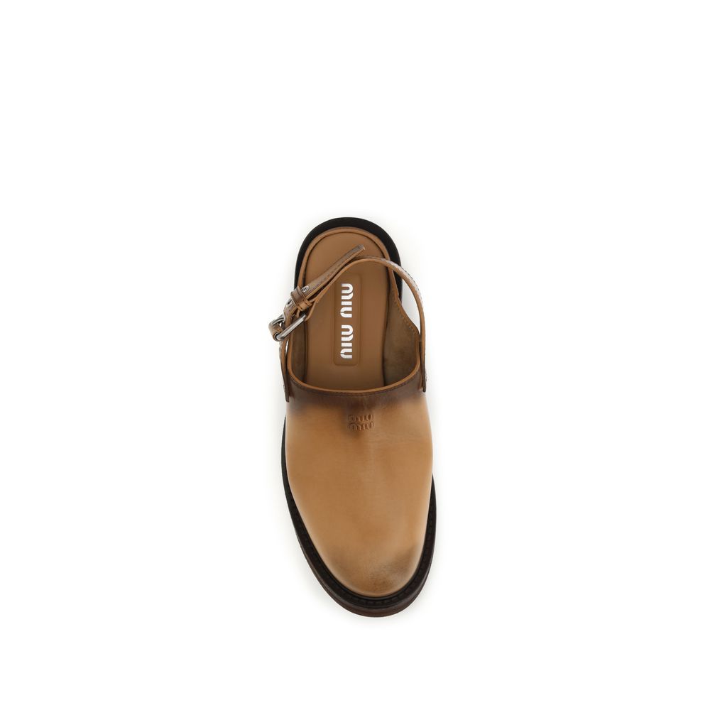 Miu Miu brown calf leather mule with a buckled slingback strap, round toe, and dark-toned gradient finish.