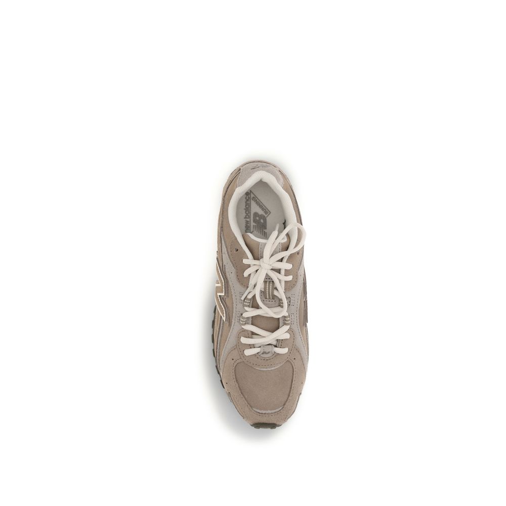 Top view of a taupe New Balance suede and mesh sneaker with cream laces on a white background.