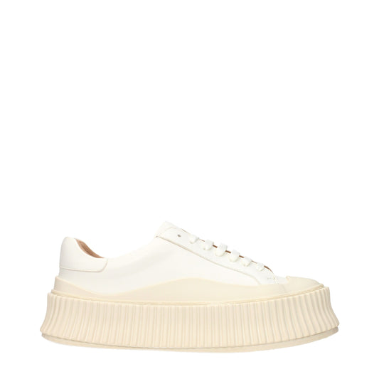 Jil Sander white leather low-top platform sneakers with a chunky, ribbed off-white rubber sole.