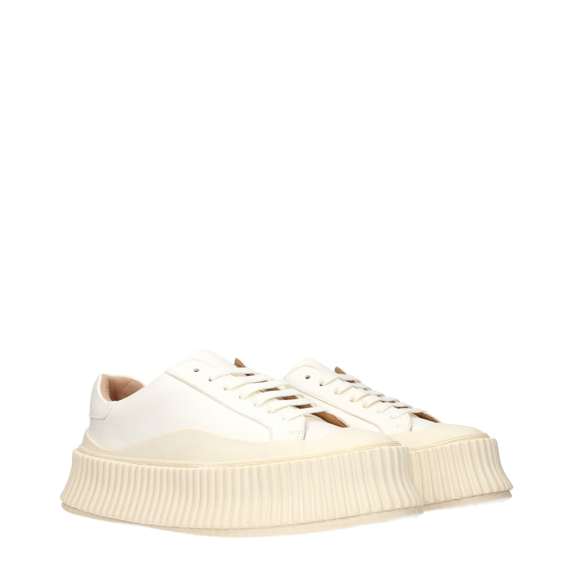 Jil Sander white leather low-top platform sneakers with a wide, ribbed off-white rubber sole.