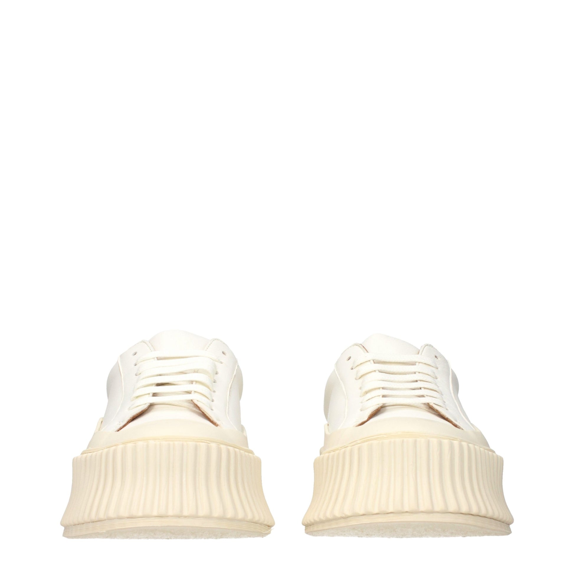 Jil Sander white leather low-top platform sneakers with chunky, ribbed off-white rubber soles and matching laces.