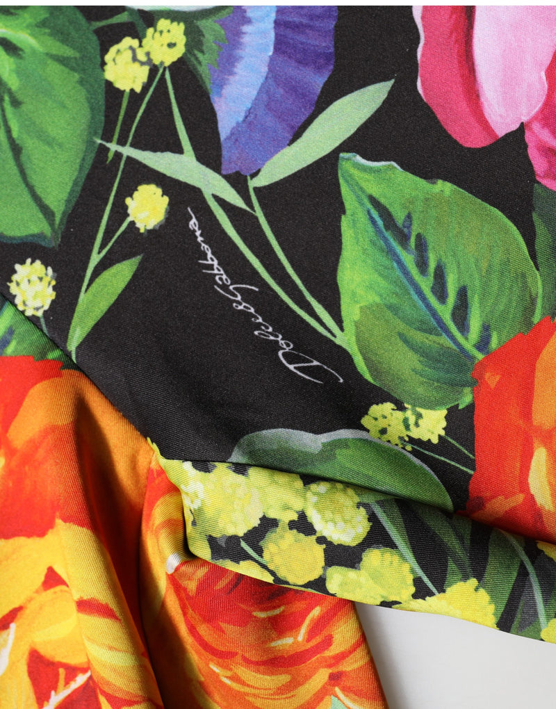 Multicolor floral stretch jersey fabric with vibrant pink, yellow, and green flowers on black