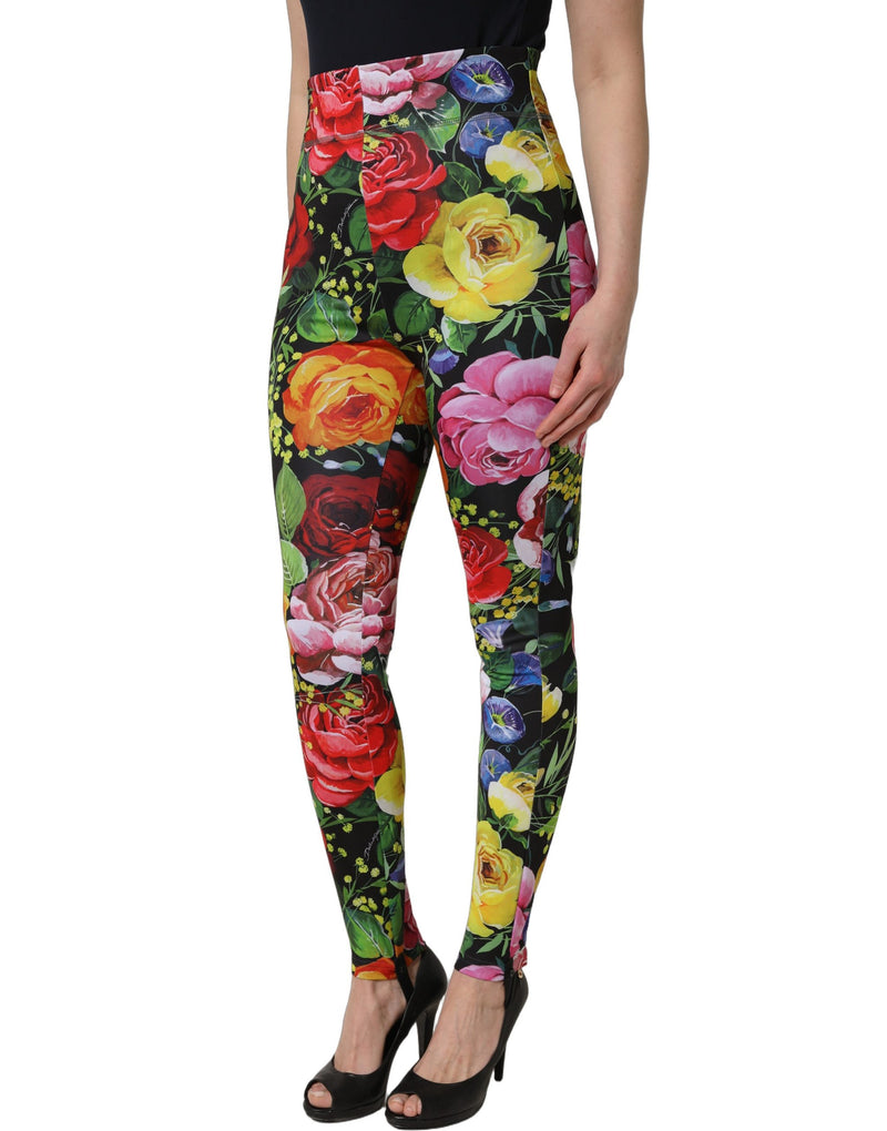 Multicolor floral stretch jersey leggings with large red, yellow, and pink roses on black background