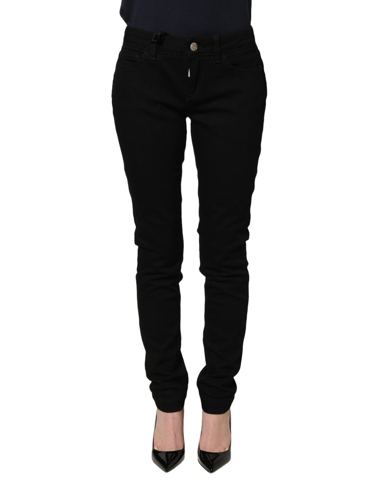 Black slim-fit denim jeans worn with black heels