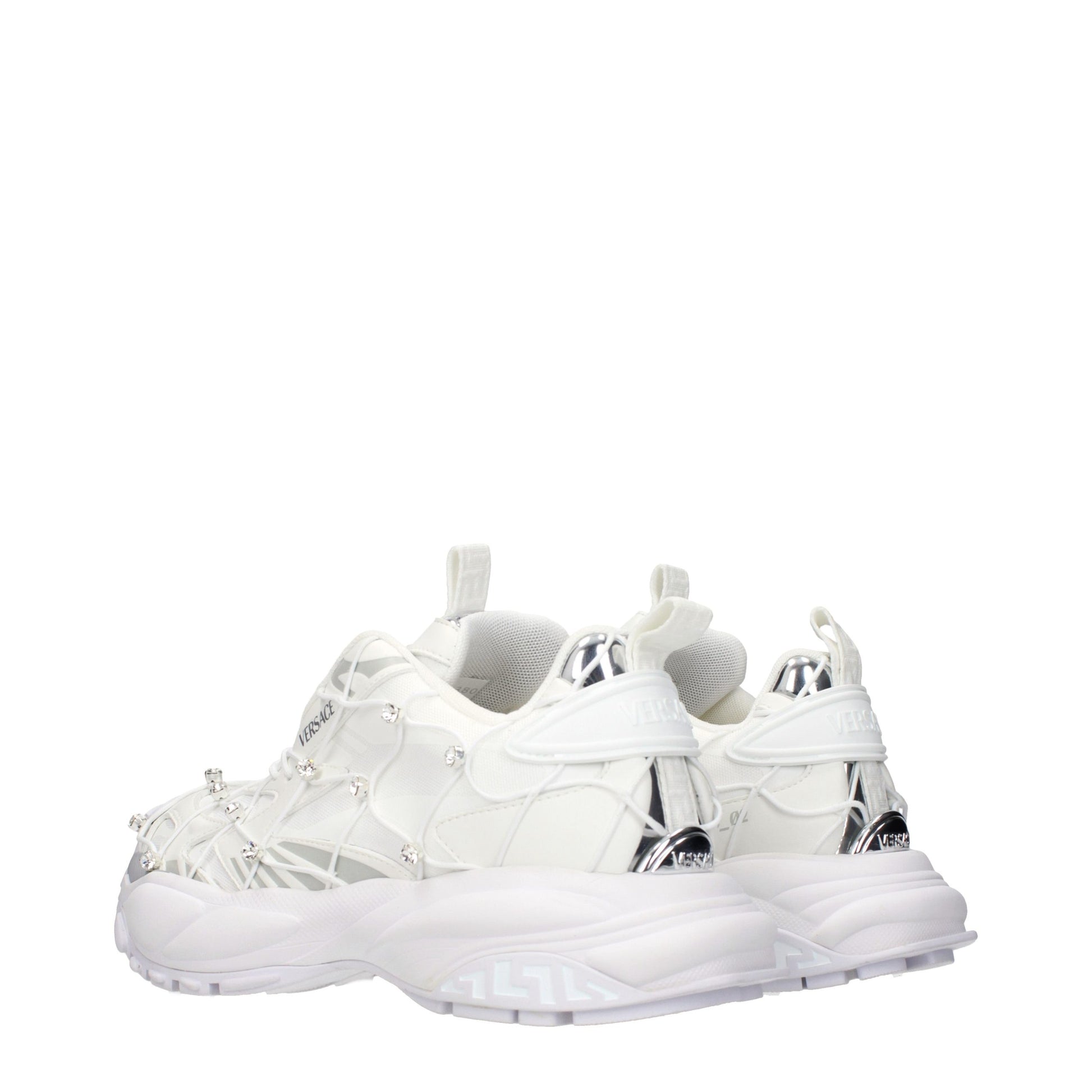 Versace white fabric sneakers with decorative crystal accents, silver metallic details, and a chunky rubber sole.