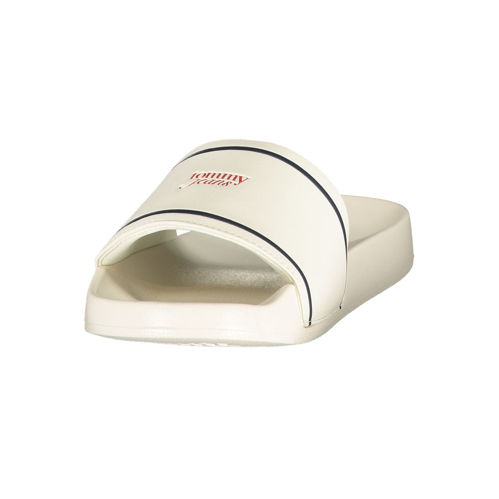 White Tommy Jeans polyurethane slide sandal with a dark trim and red logo detail.