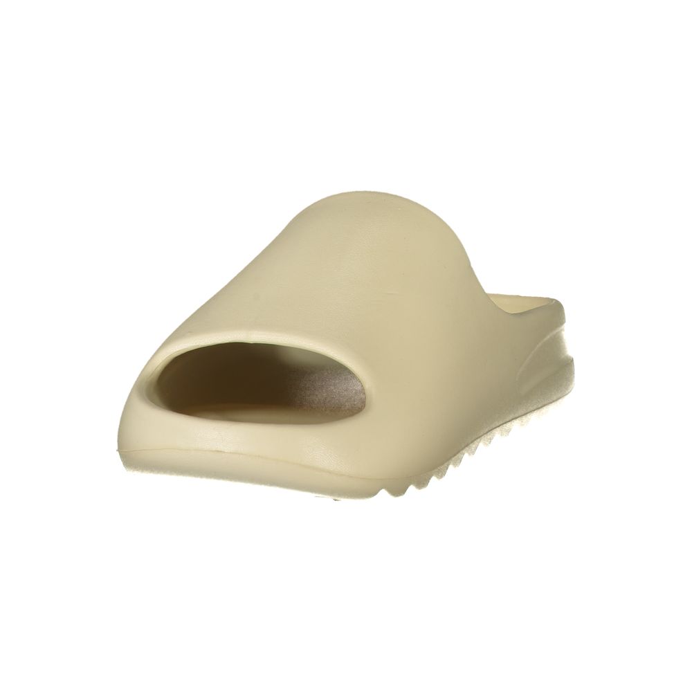 Beige polyurethane women's slide slipper with a minimalist, thick-soled design.