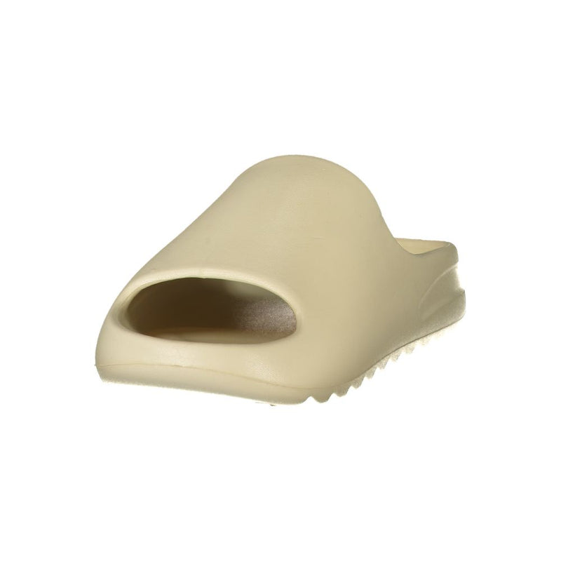 Beige polyurethane women's slide slipper with a minimalist, thick-soled design.