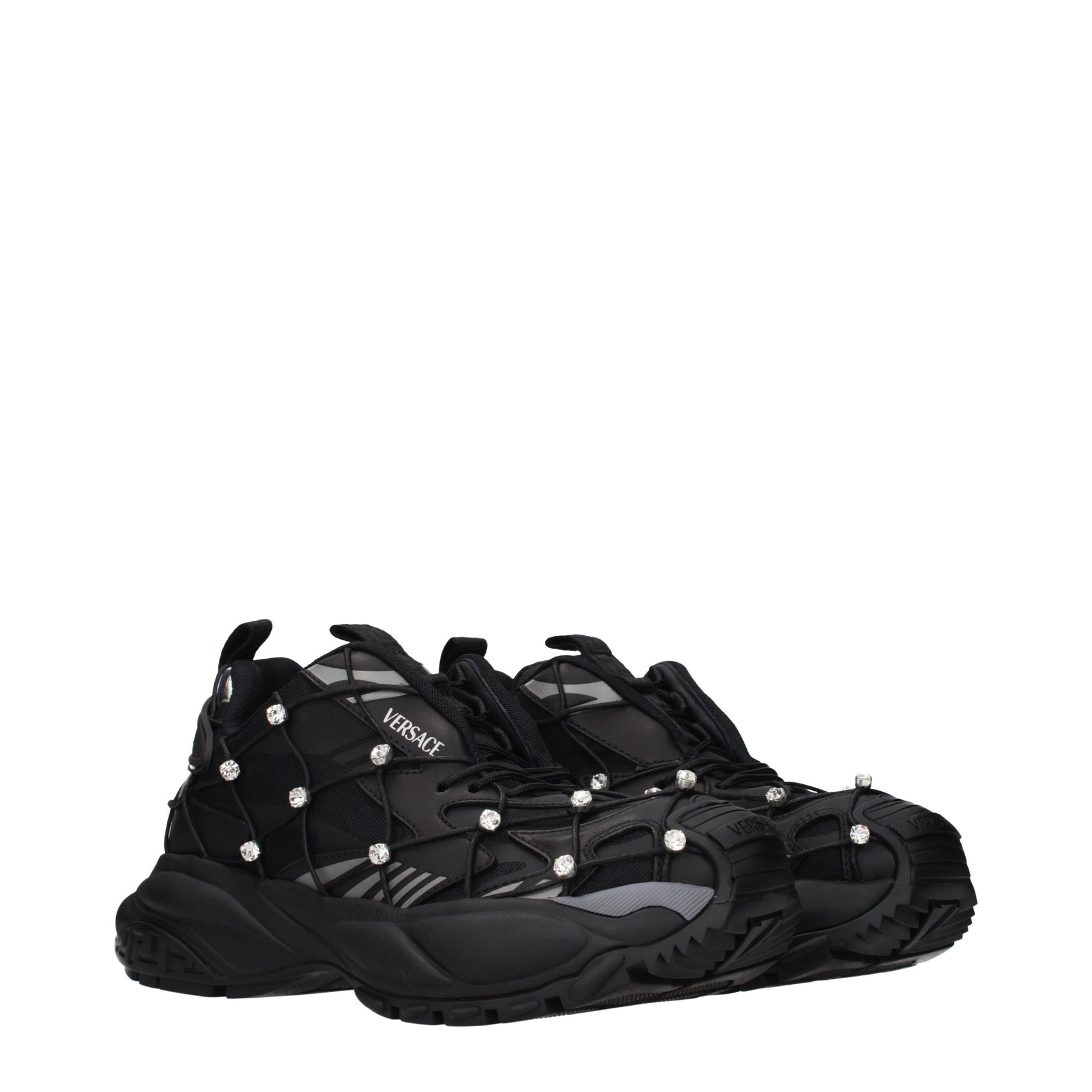 Versace black chunky sneakers in mesh and fabric, featuring crystal-studded cage overlays and thick, sculpted soles.