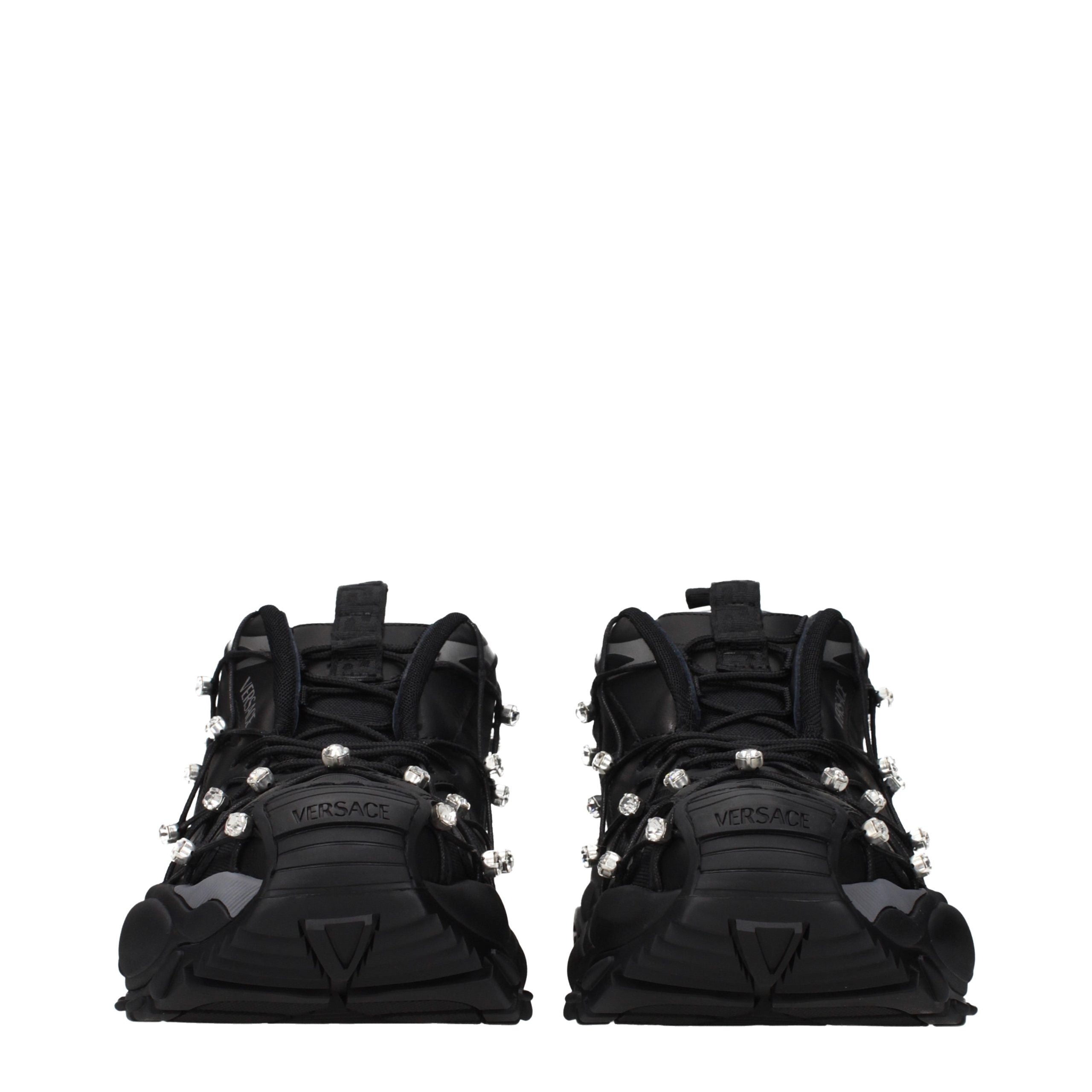 Versace black fabric chunky sneakers with crystalline embellishments and a thick, ridged rubber sole.