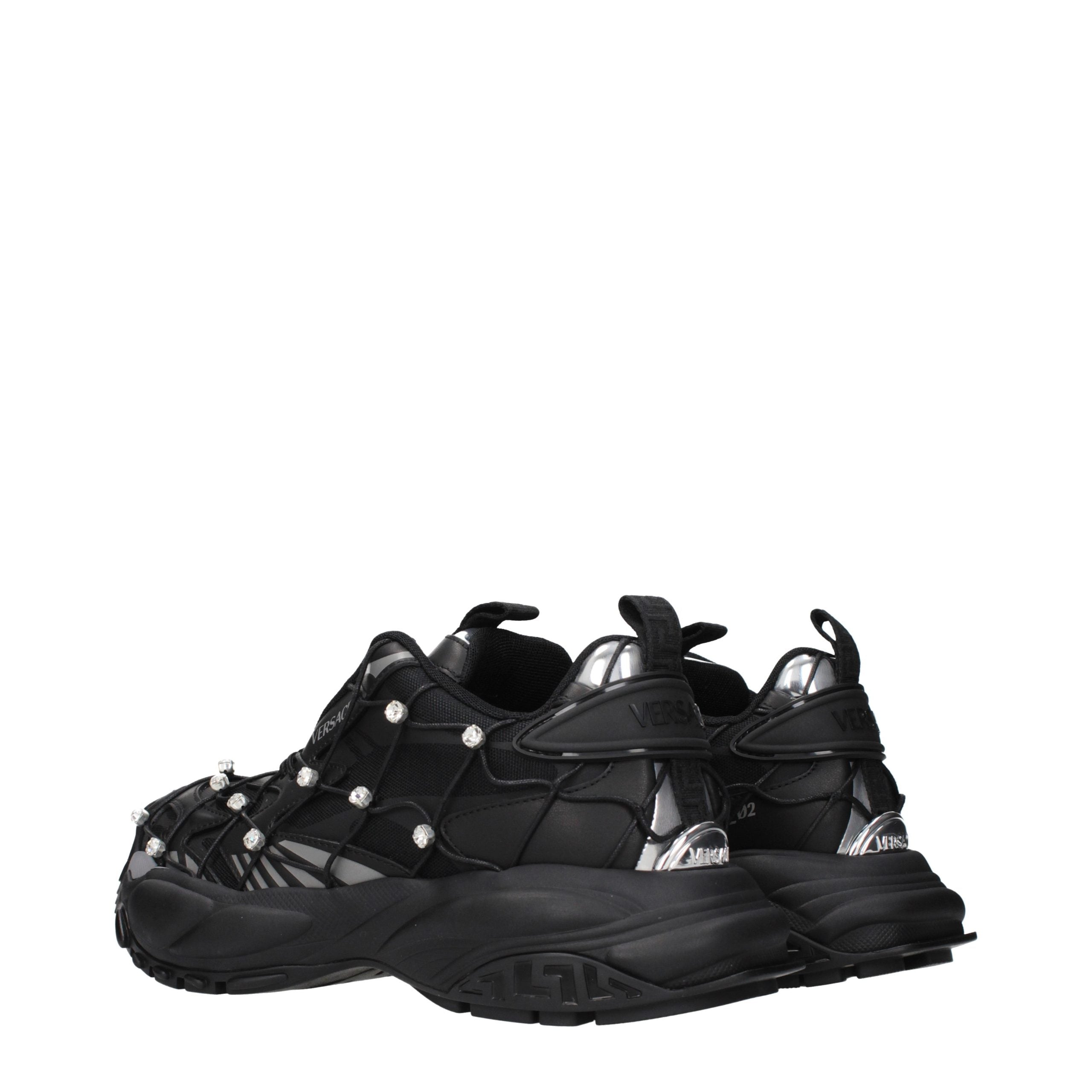 Versace black fabric chunky sneakers with cage-like overlay, crystal accents, and silver metallic heel details.
