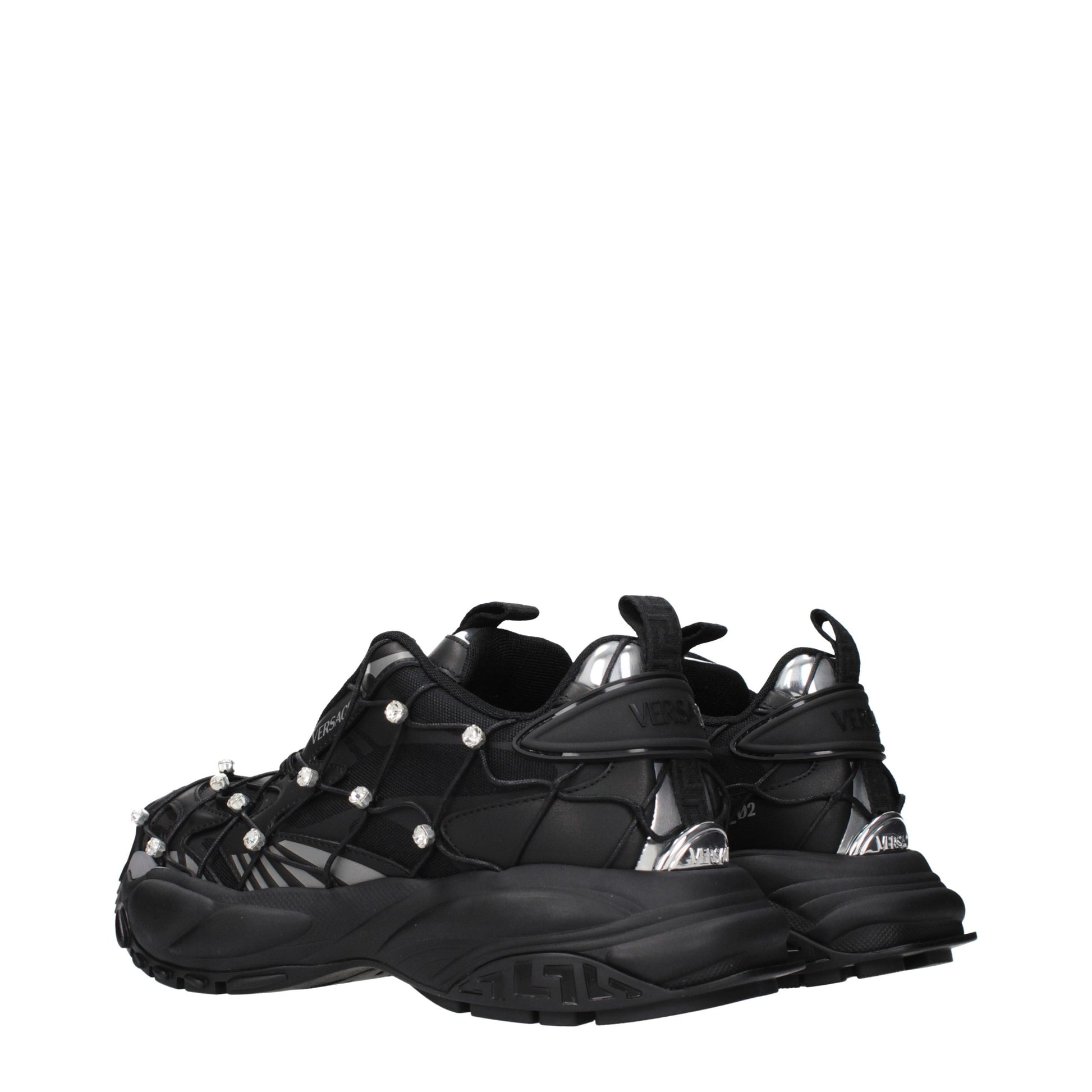 Versace black fabric chunky sneakers with cage-like overlay, crystal accents, and silver metallic heel details.