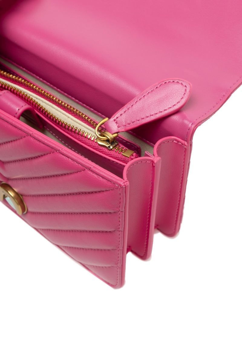 Open pink quilted leather shoulder bag showing the interior zipper compartment