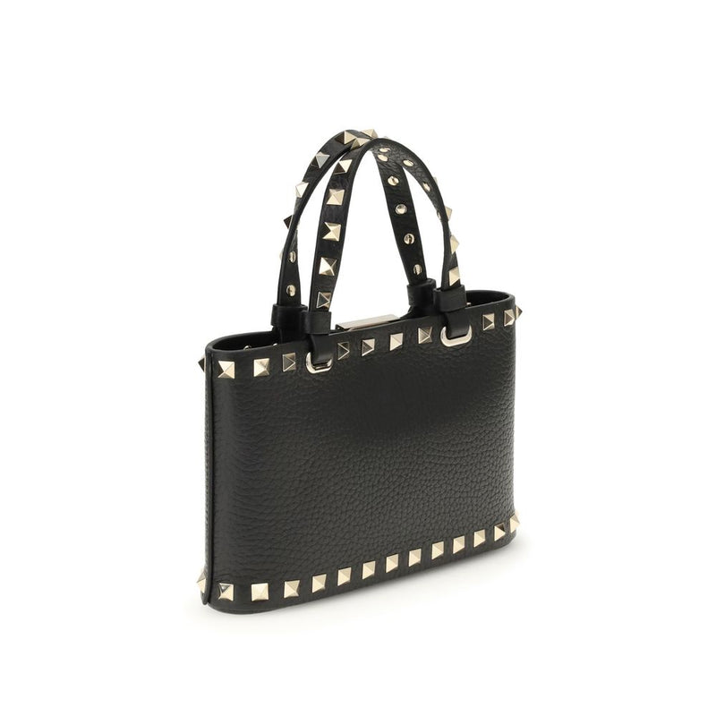 Black leather handbag with gold studs and dual top handles