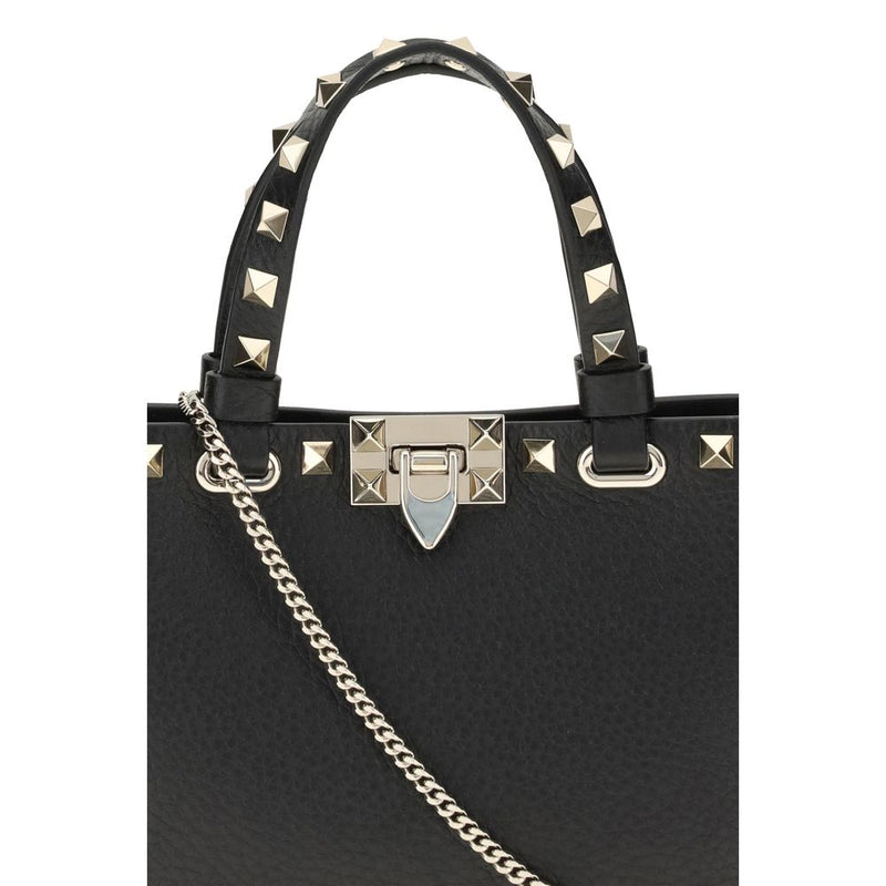 Black leather handbag with gold studs and a chain strap
