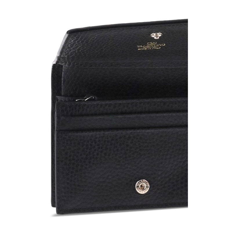Black textured leather wallet open to show card slots and snap closure