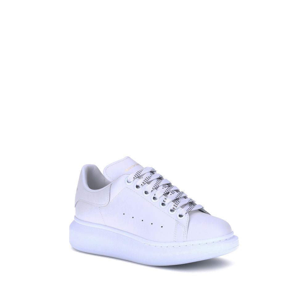Female model wearing Alexander McQueen white calf leather Bos Taurus platform sneakers with a clean white upper, premium leather finish, and signature oversized chunky sole, captured mid-step in a casual lifestyle pose showcasing the shoe's iconic silhouette and luxurious detailing.