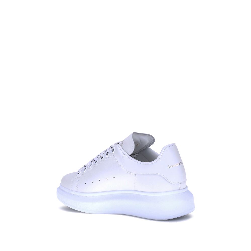 Female model wearing Alexander McQueen white calf leather Bos Taurus platform sneakers with a clean white upper, premium leather finish, and signature oversized chunky sole, captured mid-step in a casual lifestyle pose showcasing the shoe's iconic silhouette and luxurious detailing.