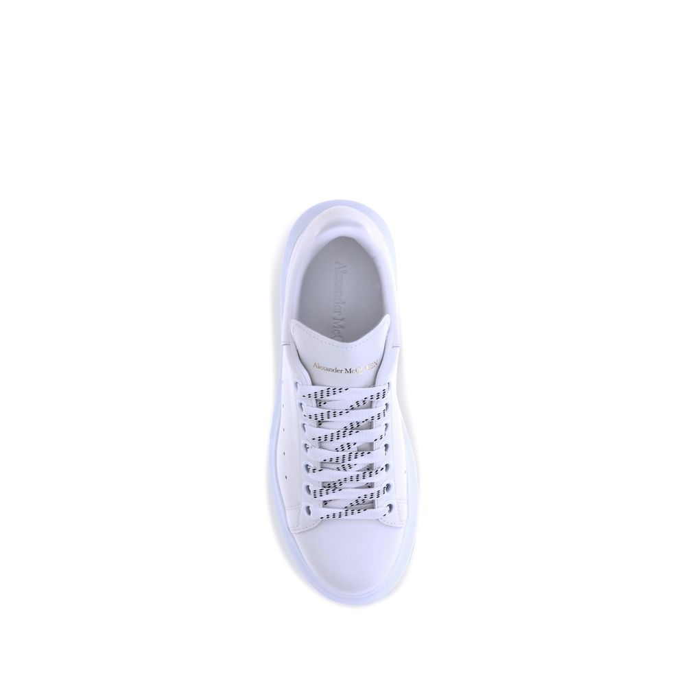 Female model wearing Alexander McQueen white calf leather Bos Taurus platform sneakers with a clean white upper, premium leather finish, and signature oversized chunky sole, captured mid-step in a casual lifestyle pose showcasing the shoe's iconic silhouette and luxurious detailing.