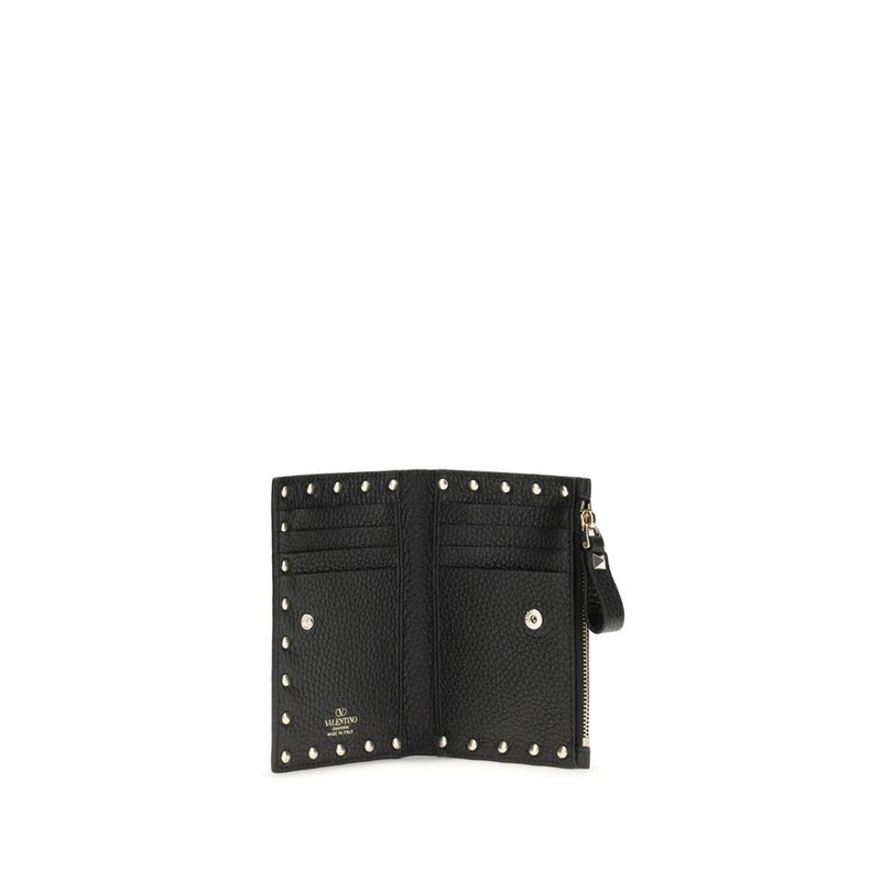 Black leather Valentino Garavani wallet open to show card slots and studs