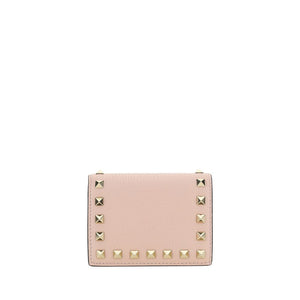 Pink calf leather Valentino Garavani wallet with gold-tone pyramid studs along the borders.