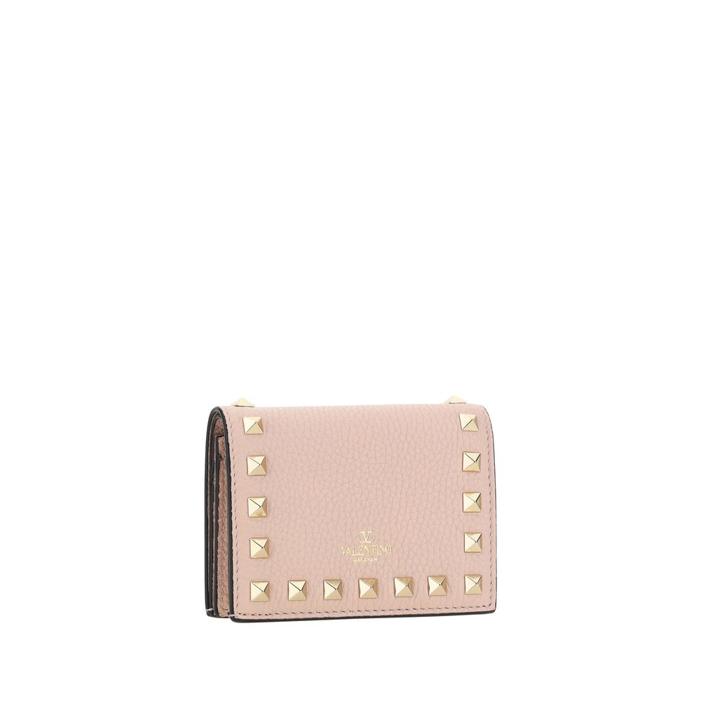 Valentino Garavani pink leather wallet with gold pyramid studs and gold embossed logo.
