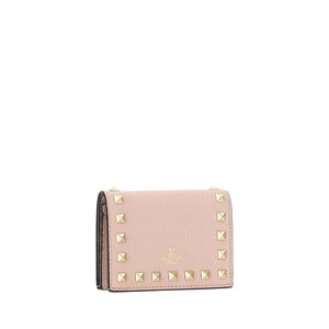 Valentino Garavani pink leather wallet with gold pyramid studs and gold embossed logo.