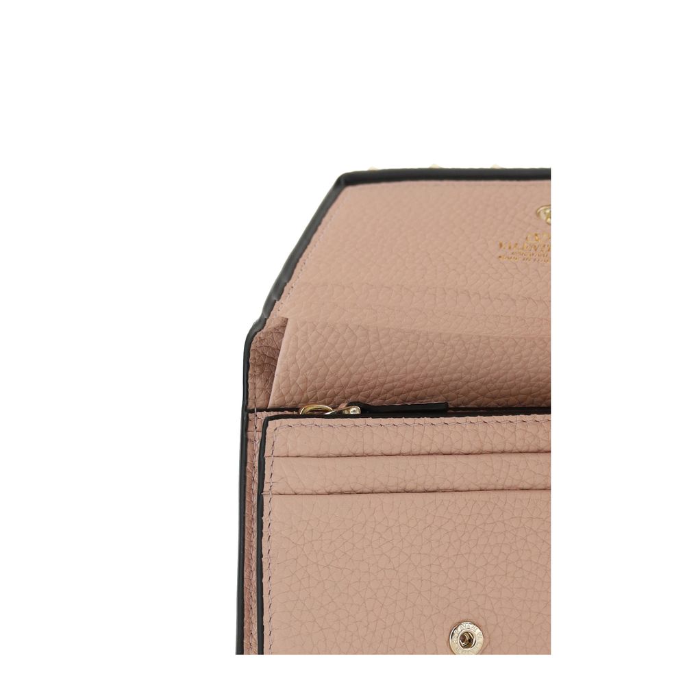 Close-up of pink grained calf leather wallet interior with card slots and snap button.