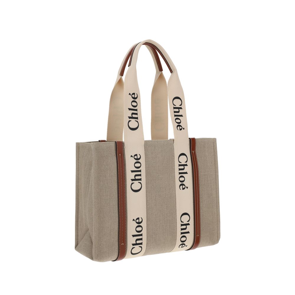 Chloé beige linen tote bag with brown leather trim and cream logo straps.