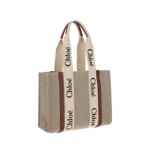 Chloé beige linen tote bag with brown leather trim and cream logo straps.