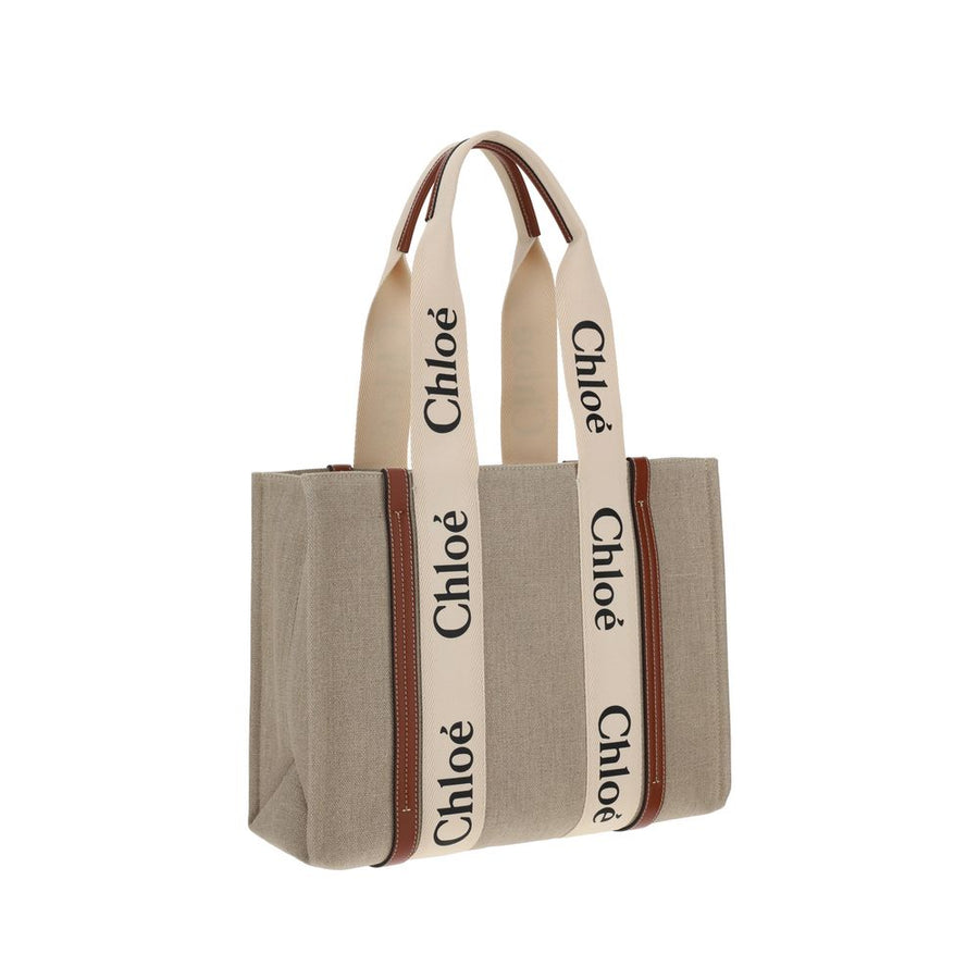 Chloé beige linen tote bag with brown leather trim and cream handles featuring black Chloé logos.