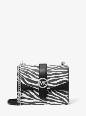 Black and white zebra print crossbody bag with silver chain strap and MK logo clasp