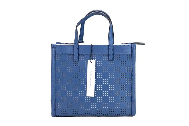 Blue perforated leather mini tote bag with top handles and a hanging white brand tag