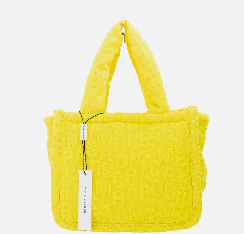 Bright yellow terry cloth small tote bag with embossed monogram pattern and two top handles