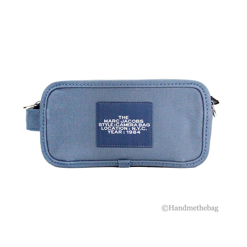 Blue canvas Marc Jacobs camera bag with a rectangular label on the front