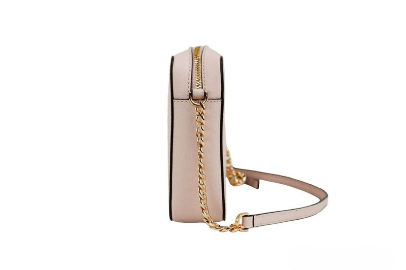 Side view of a powder blush leather crossbody bag with a gold chain strap