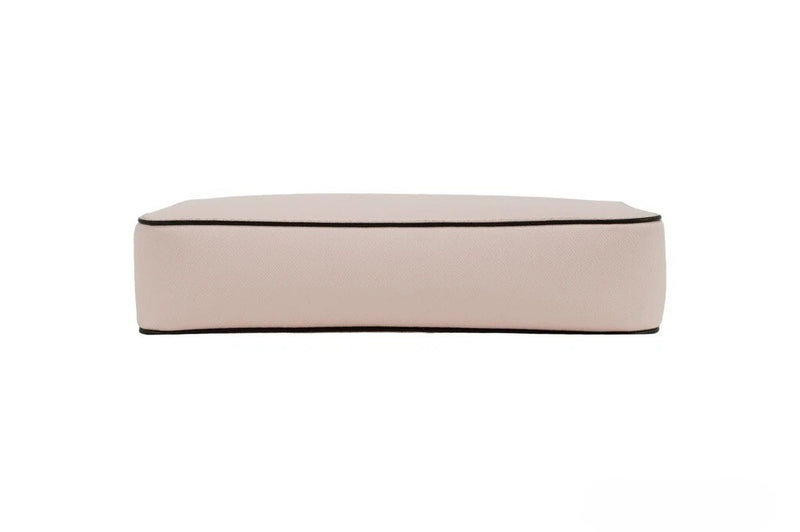 Powder blush pink textured leather crossbody bag shown from the bottom side