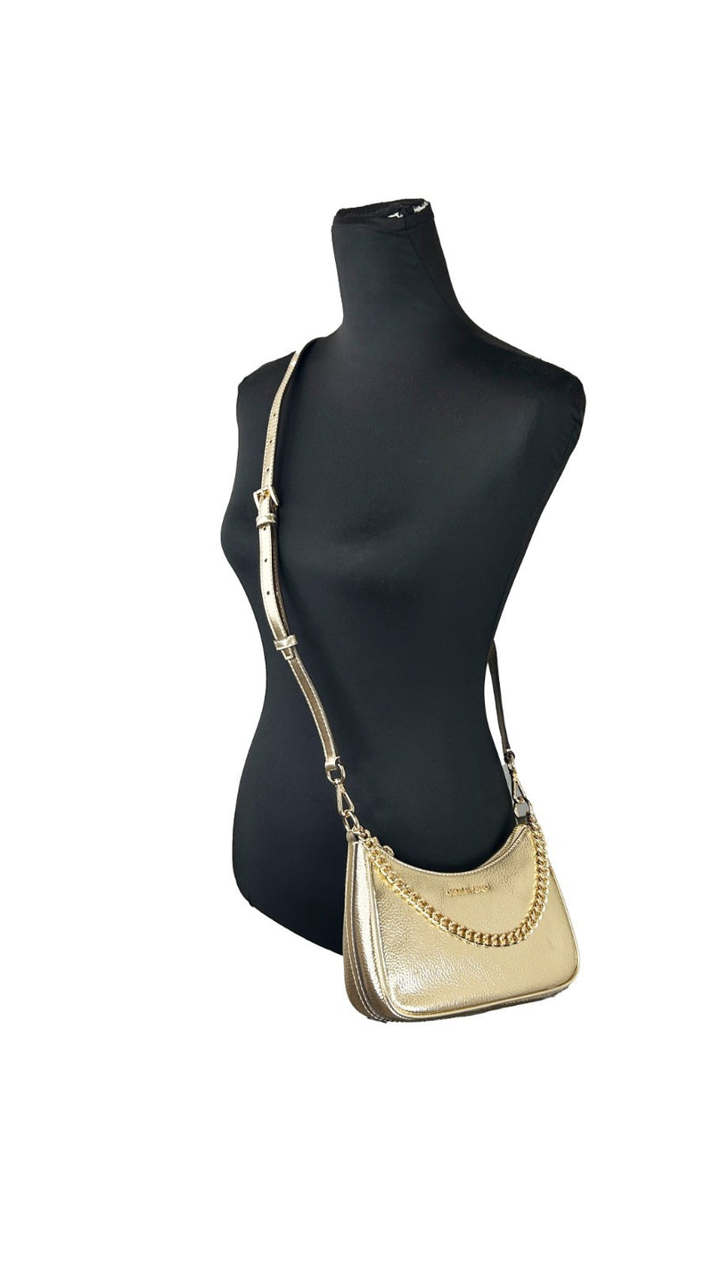 Gold metallic leather Michael Kors pouchette crossbody bag with a chain strap worn on a black mannequin