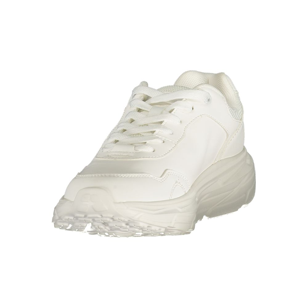 Female model wearing U.S. POLO ASSN. white polyurethane women's sneakers with a clean white upper, branded logo detailing, and sporty white sole, captured mid-step in a casual lifestyle pose showcasing the shoe's fresh profile and classic athletic style.