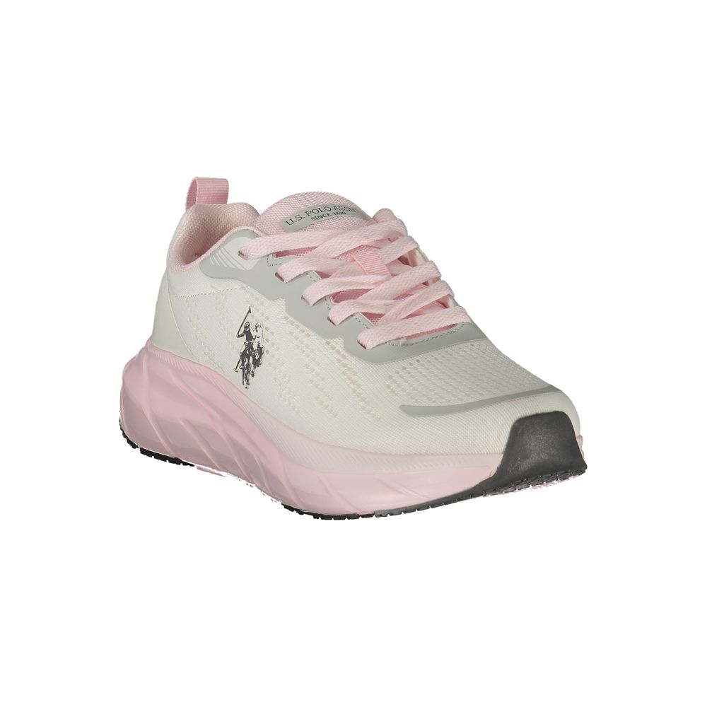 Female model wearing U.S. POLO ASSN. white polyurethane women's sneakers with a clean white upper, signature polo branding, and sporty white sole, captured mid-step in a casual lifestyle pose showcasing the shoe's sleek profile and everyday athletic style.