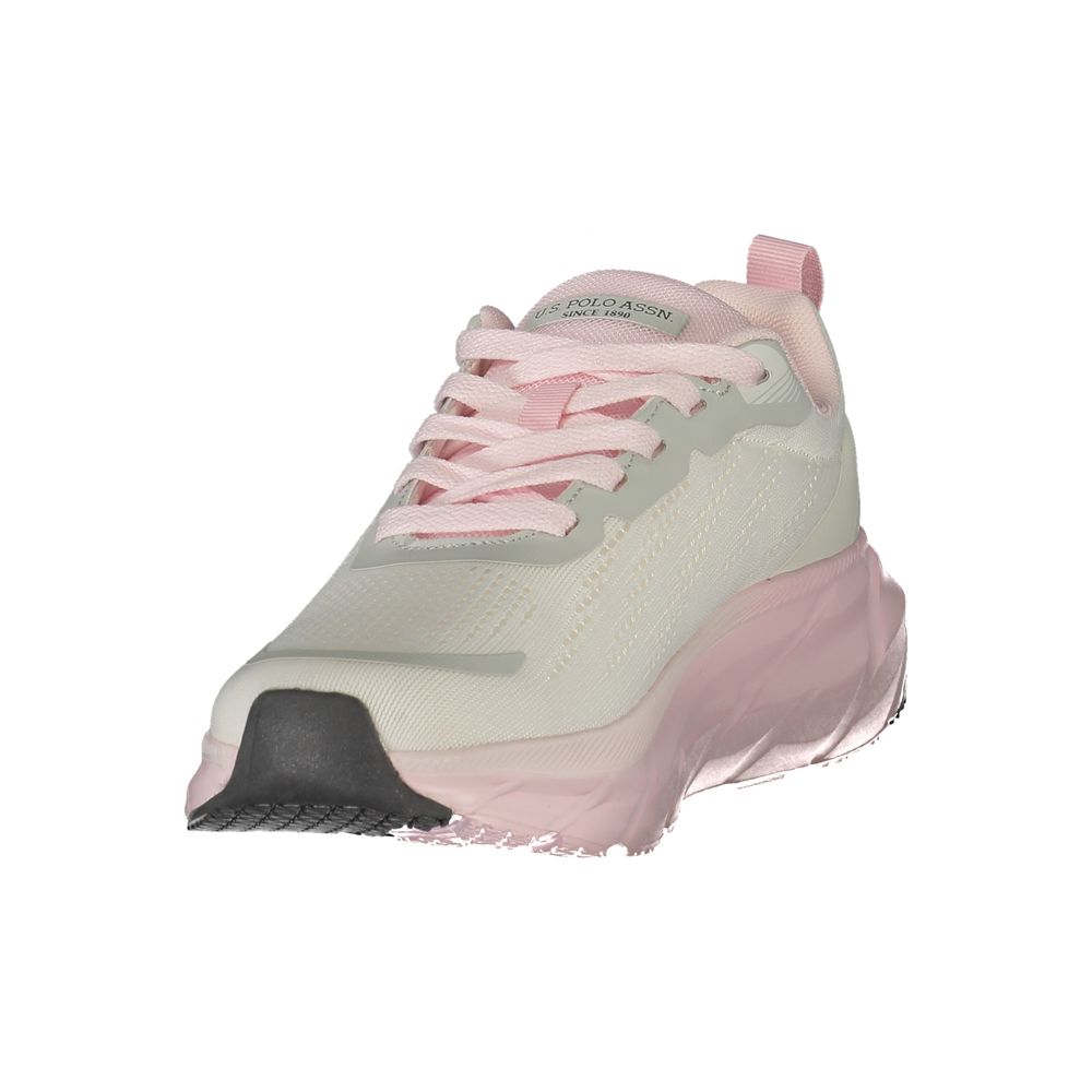Female model wearing U.S. POLO ASSN. white polyurethane women's sneakers with a clean white upper, signature polo branding, and sporty white sole, captured mid-step in a casual lifestyle pose showcasing the shoe's sleek profile and everyday athletic style.