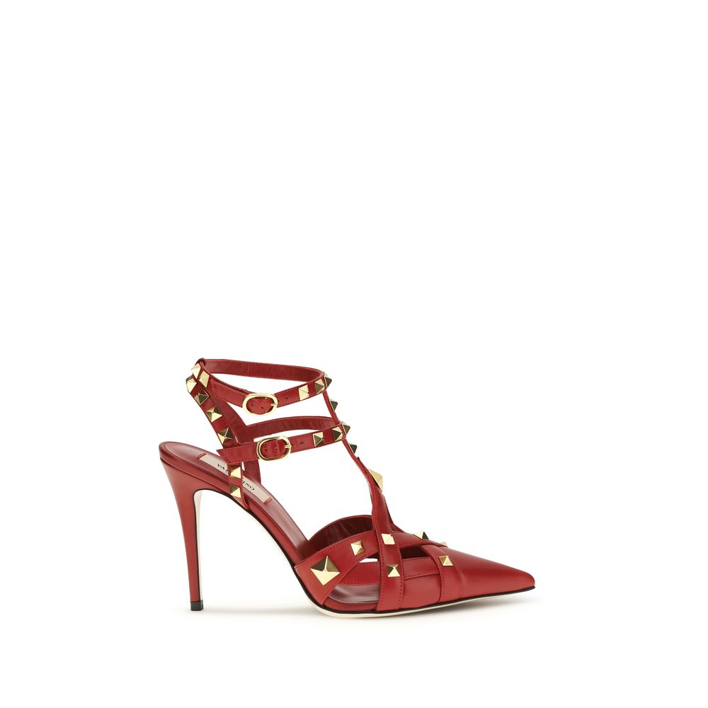 Red goatskin leather pointed-toe high heel pumps with gold-tone pyramid studs and double buckled ankle straps.