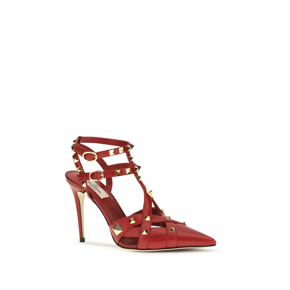 Red goatskin pointed-toe high heel pumps with gold-tone stud embellishments, caged straps, and buckle closures.