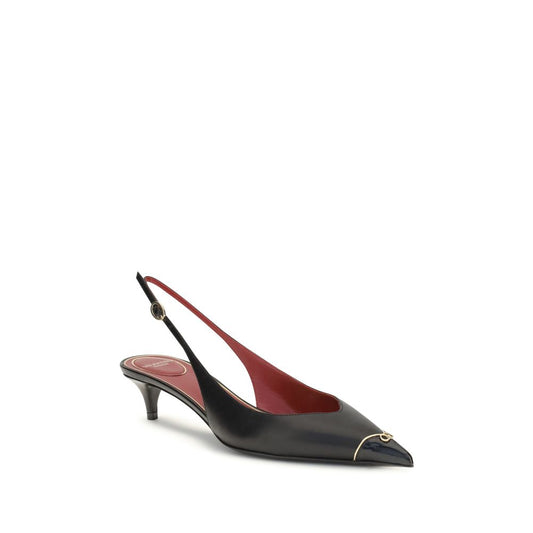 Black leather slingback pumps with a pointed toe, gold-tone metal tip, kitten heel, and red interior.